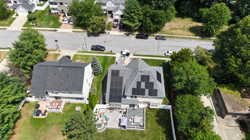 Aerial summer view of a residential solar panel array in a neighborhood setting